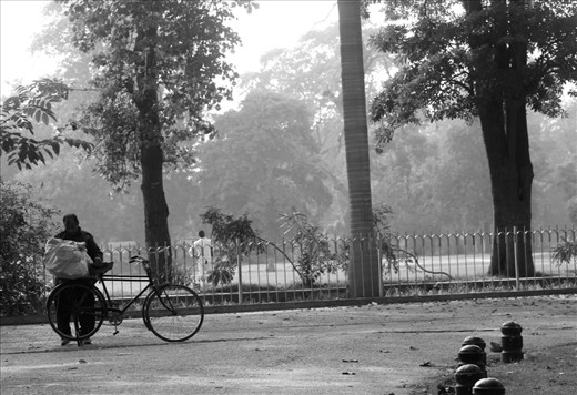 A local Laundry man about to take washed and ironed clothes to his customers on his bike