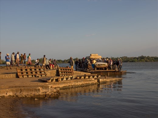 Ferry number 9 and the trade of diesel for right of passage. Small children swim in the water but adults are afraid and hold on tightly to the car. 