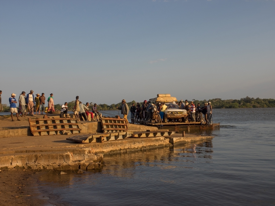Ferry number 9 and the trade of diesel for right of passage. Small children swim in the water but adults are afraid and hold on tightly to the car. 