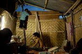 A father sips his beer as his amused son climbs the walls of the bamboo house to play with the chickens that are nesting on the roof. (Lamphun, Thailand): by sara_callow, Views[629]