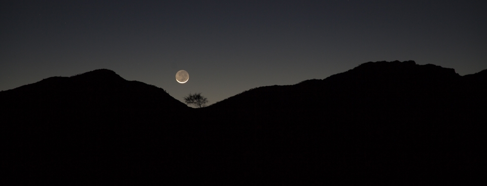 One the way back to Wilpena Pound one evening the moon was going down.  The tree in the dip of the perimeter of the pound stood out.  It is by the light of the silvery moon.  It was so serene and the night sky was amazing with very bright stars.  I think it was nature showing a softer side of the Flinders Ranges but the tree by itself, also emphasised the isolation of the area.  The silhouette of the image also hides a lot of the unknown of the area.