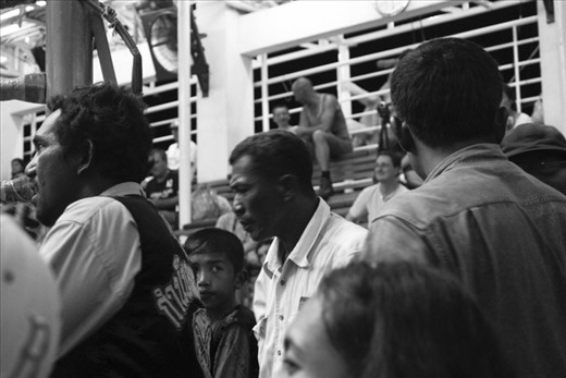 A younger brother of a competitor anxiously awaits the outcome. 