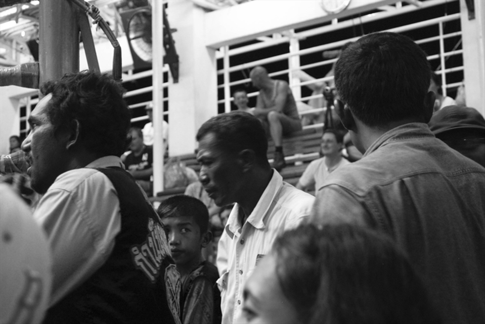 A younger brother of a competitor anxiously awaits the outcome. 