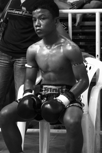 The oil glistens upon a competitor as he waits for his fight to commence.