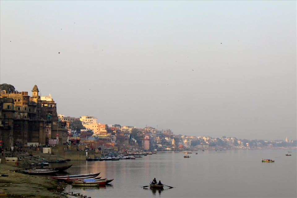 A coastal view of several ghats along the Ganga River, mid-day. 