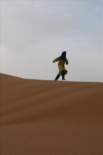 Despite the nearly 100 degree Fahrenheit heat, one guide ditches his soft leather shoes and runs up and down the dunes barefoot in his heavy garb. His laugh echoes on the wind as he runs, his sense of freedom clear.