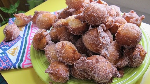 Delicious orange doughnuts, rolled in cinnamon sugar.