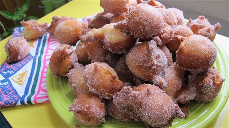 Delicious orange doughnuts, rolled in cinnamon sugar.