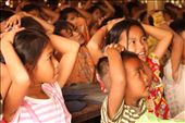 The only way this girl can attend her local village school is by taking her two-year-old brother along, while the parents are working in the fields. The boy sits quietly in a single class of 150 students, immitating everything they do.: by sash, Views[560]
