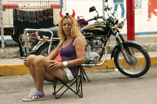 Although women don't dress up as devils, many do take part in the ritual following the parade, providing water and food or simply enjoying the view from a comfortable chair.