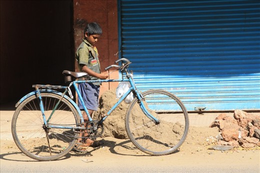 Young boy pauses on his way back from school in Panaji, the capital of Goa, India.