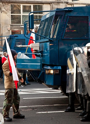 A Polish nationalist holds his ground in front of police during the 2011 Independence Day march. As with many nationalist movements, violence often occurs with the presence of the political right wing. In this situation police had blocked a street in Warsaw as well as using tear gas and water cannons to disperse the crowds.
