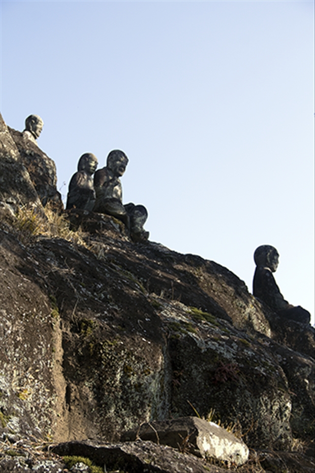 Budhhas - Sitting on the side of a hill below the town's main temple.