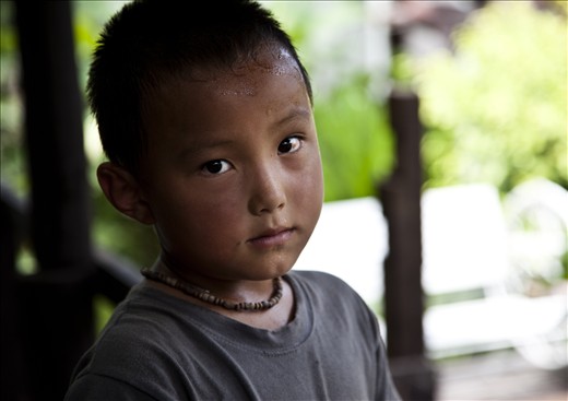 Thai Boy in Ayuttuya feeling the heat after showing me some critters in a pond.