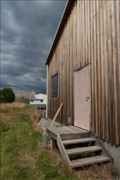 On the banks of the quiet Huon River a weathered boat shed stands proud in the face of a building storm.: by scottnolan, Views[573]