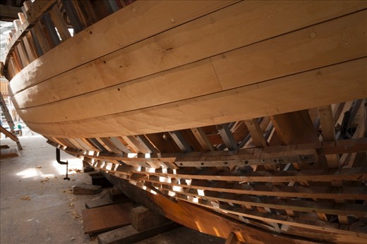“Peggy” a 22ft Yacht designed and built by Adrian Dean and named after his wife. At its current state, Huon Pine planks begin to enclose the skeleton of the hull as light leaks through the uncovered areas.