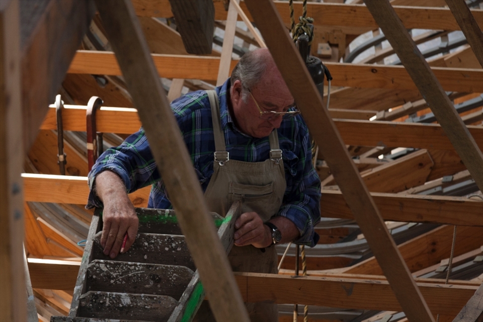 Master craftsman and educator Adrian Dean working in the belly of the beast.