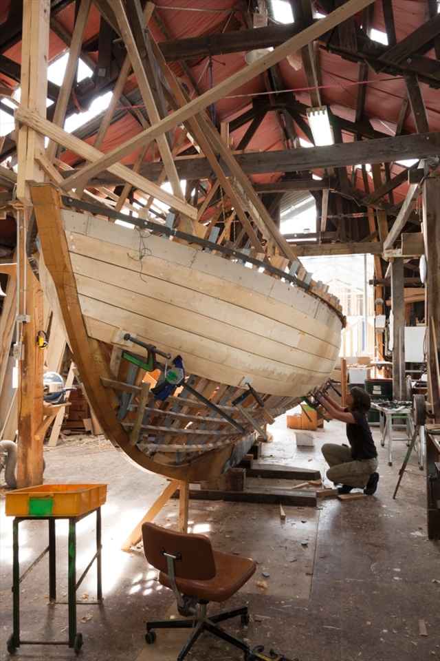 Adrian's student works on 'Peggy', continuing the traditional craft of boat building.