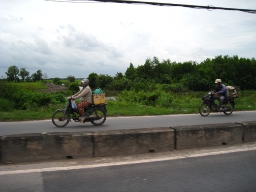 If you look at the second motorbike there is a dog in a cage on the back - dinner apparently..