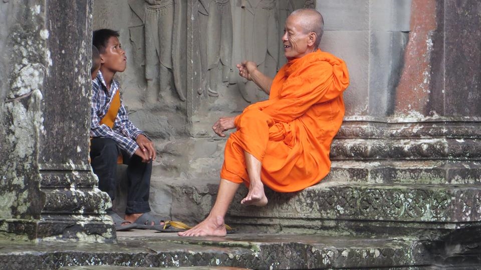 I was visiting a temple, when it began raining pretty bad. I was all wet, so I went inside the temple and I found this monk with this boy. It seemed to me the monk was explaining something important to the kid and he was just pretending to listen, making that face that most of the students have sometime, when they are thinking at something else. 