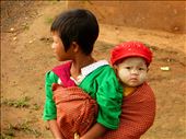 Little girl and her sister in a Myanmar village, near Inle Lake. 
I slept in that village the night before and when I got up to have breakfast, I found this little girl with her sister on her back. The baby had a special cream on her face made by the bark of a tree; it protects from the sun when you work in the fields. : by sea_2014, Views[398]