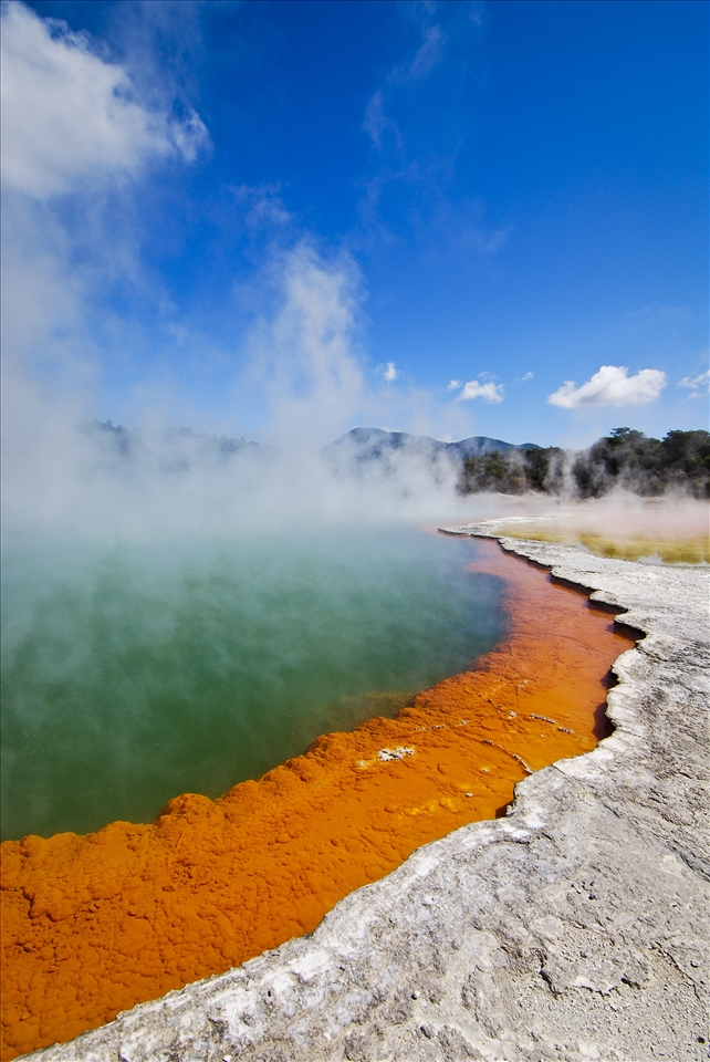 The colorful Champagne Pool located at Waitomo New Zealand is a 700 year old explosion crater filled with hot water spring. It has steep sides and 62 metres deep. The orange colored edge contains arsenic and antimony sulphur compounds rich in minerals including gold and silver. New Zealand has a lot of volcanic wonders, such as the Tongariro National Park (where the Lord of The Ring was filmed), Lake Taupo, and Rotorua.