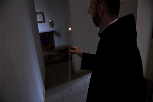 A candle is ignited and walked past each monk whilst lighting every candle from the same source of fire