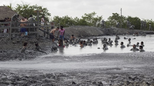 The mud volcano. People encourage a man to come down, it's 40m diam*40km deep!!