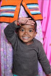 This boy in Tordi Gat shows nothing but pure innocence and happiness - looking directly at the lens , greeting with his right hand I aimed to capture both the joy of this boy from his expression and also the intimacy of a boy and his mother - who symbolically is right behind him ,