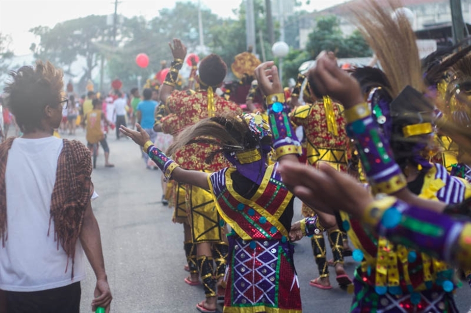 Paraders in full Sinulog costume walk into the Blessed Sacrament Parish in Cebu City where the parade comes to an end late in the afternoon.