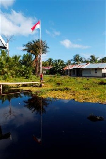 Indonesian Flag, standing in the middle of swamp in Marore Island