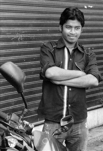 Dharavi - Mumbai - Young mechanic standing behind his motorbike
