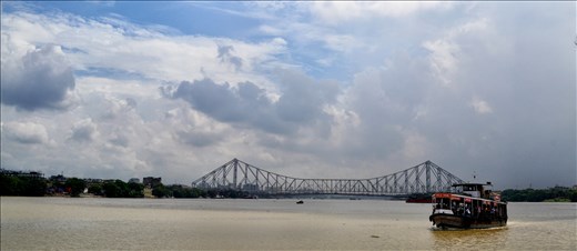 A streamer on Hooghly river with Howrah bridge in the backdrop, Kolkata