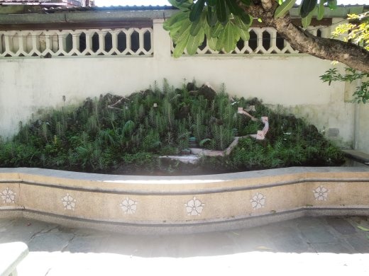 Miniature fountain behind the temple
