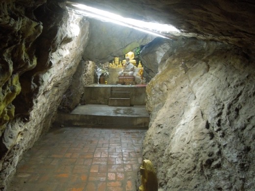 Peering through this little cave shrine to the Buddhas within- this shrine is called Wat Tham Phu Si.