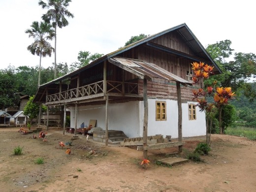 We hike up to a hill tribe village that is actually 3 tribes living together in one joint village... our guide explained you could tell this by their unique styles of architecture. For example this 2-story house with windows is very different from the houses we saw nearby...