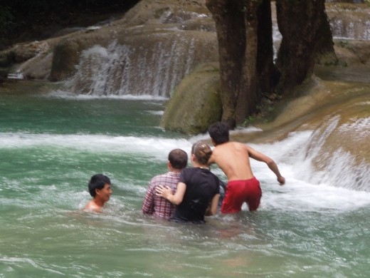 I am clutching Sam trying not to fall off. Our elephant refuses to come up out of the water.