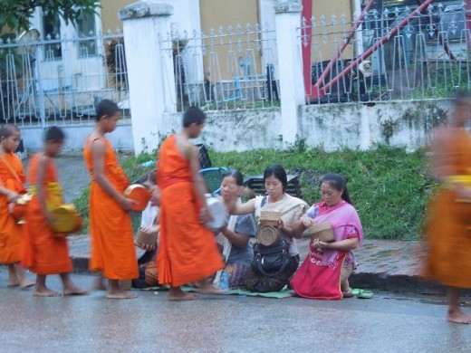 Local villagers offer rice to the monks every morning-- this is how the monks are fed- they are completely dependent on the charity of the village