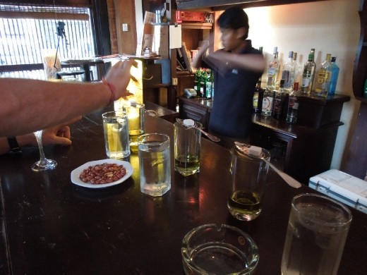 We find a bar! A real bar! Like, that pours full drinks! To celebrate, we drink Absynthe.