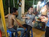 Guy getting a bamboo needle tattoo right on the street at the market... say what?: by sglass, Views[1137]