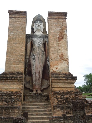 A standing Buddha symbolizes him bestowing blessings or taming evil forces