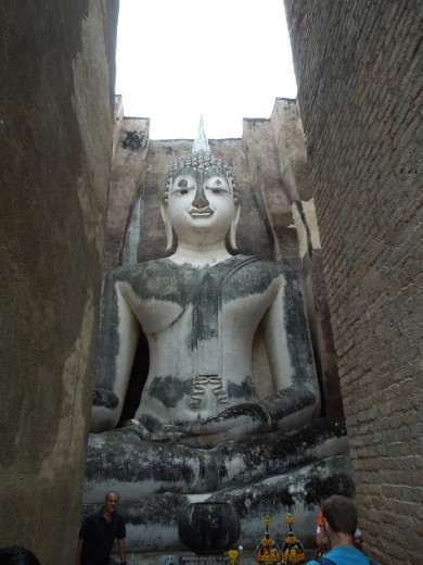 Entering the skinny passage (after removing our shoes) and looking up at the Buddha