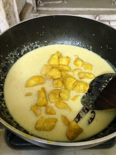 Adding the chicken back into the curry