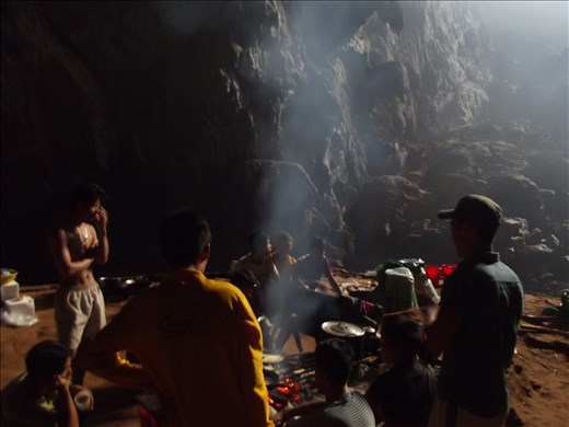 Real 'Strong' Men cook dinner. Porters relaxing around the fire at camp.