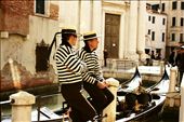 Venice is home to the picture-esque canals, romantic gondolas, and colorful buildings.  Here two gondoliers tie up their gondolas to take a break from the crowds and relax.: by shawn_paone, Views[924]