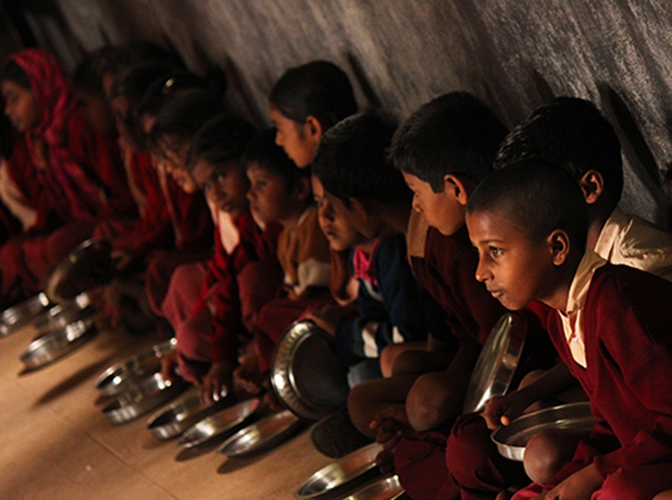 Students line up and eagerly wait for the day's special lunch. In this and many other nearby villages, residents are lucky to receive one meal of rice a day, and thus malnutrition becomes a major issue, especially to kids.