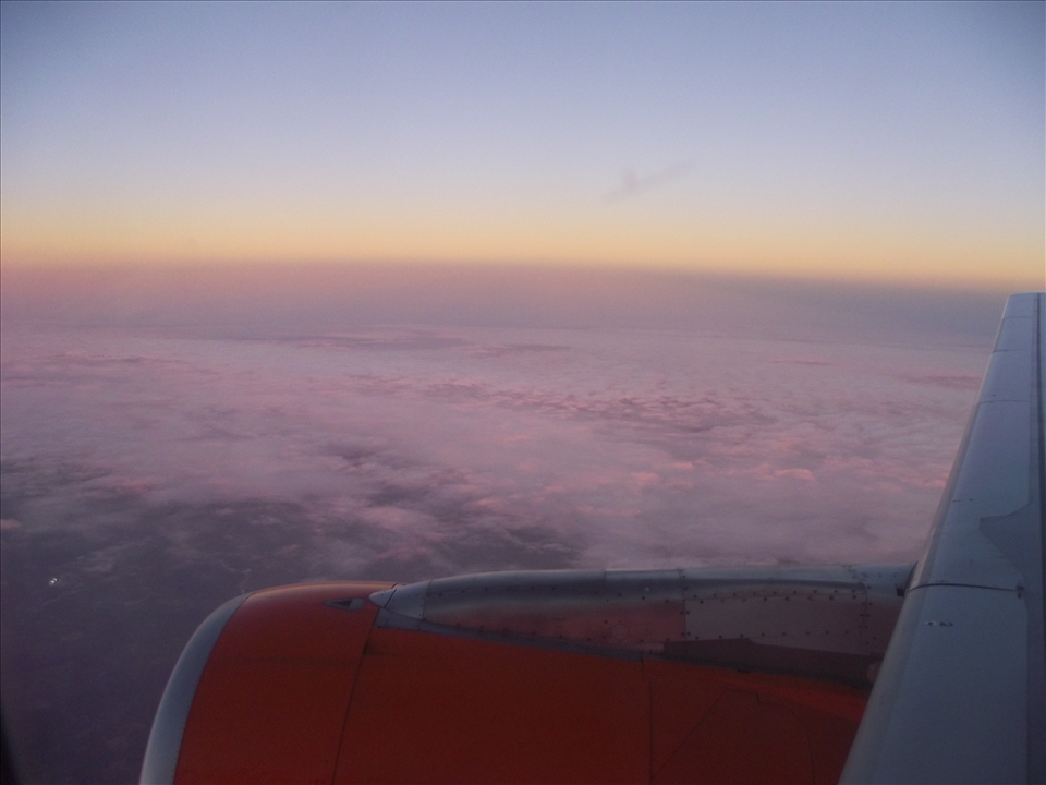 Wing of the plane and clouds