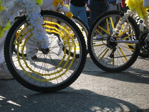 The adorned bikes and riders start the Saint Day parade.