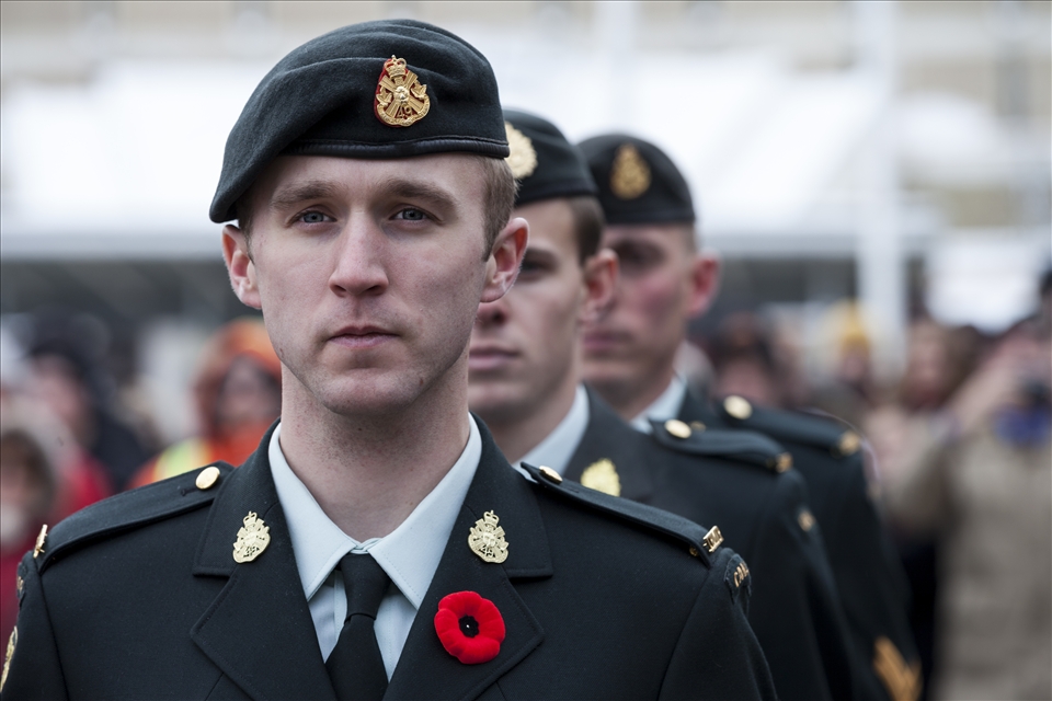 The cold chill bites exposed flesh and the soldiers stand alert, reflecting on their own journey to serve and protect our nation.  It is an impressive crowd of dedicated on-lookers braving the November frost-laden air to take in “a moment of silence” to honour all soldiers of war. The heavy silence lays like a cold blanket, cascading over the thousands present.  Only the reverence of the moment is a warm embrace holding the chill at bay. The eyes of the soldier penetrate right through the crowd, as his intense gaze reveals the deep sadness and emotion that lurks in his eyes.