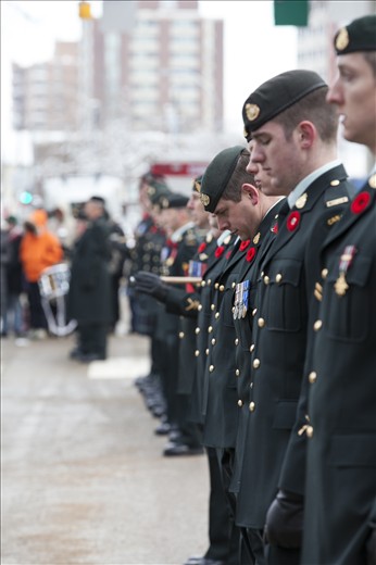 The City Centre resonates with silence as the soldiers bow their heads to pay tribute to Canadians lost in war.  The sincerity of the soldiers’ homage is magnified by their bowed silhouettes, which fade to the distant towers that reach upwards from the concrete.  Like the crosses standing row by row in Flanders Fields, as depicted in the poem by Canadian John McCrae, the lines of soldiers are rigid with purpose.  Only the water crystals in their breath shimmer in the bright sun to form wisps of smoke, and then gently fall to the ground as ice droplets. 
